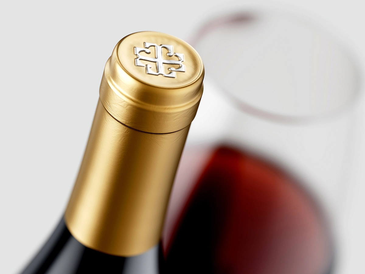 Theranda wine bottle capsule with embossed emblem in gold finish