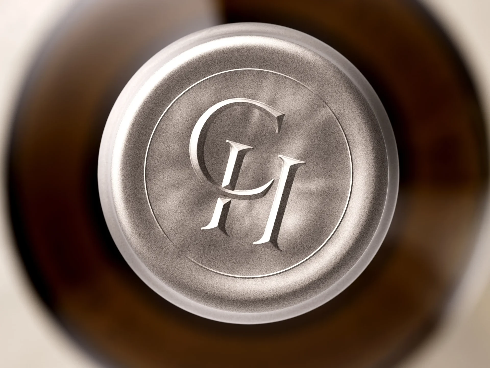 Extreme close-up of cobalt gray wine capsule with roof-embossed CH monogram — custom wine capsule printing by Dagaprint